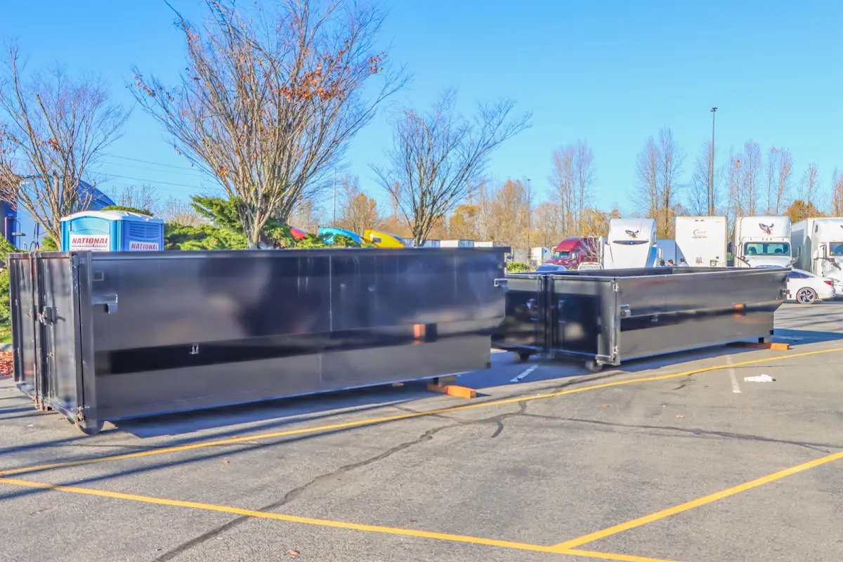 Professional dumpster rental service with roll-off container on residential driveway in Epsom